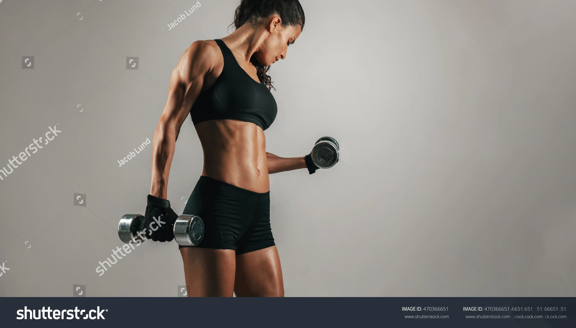 Supplied watermarked fitness context photograph of a woman holding dumbbells; not EMVY equipment